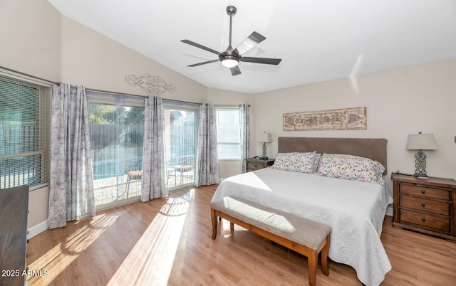 bedroom with access to exterior, lofted ceiling, a ceiling fan, and wood finished floors