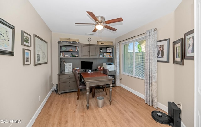 office space featuring ceiling fan, light wood-style flooring, and baseboards