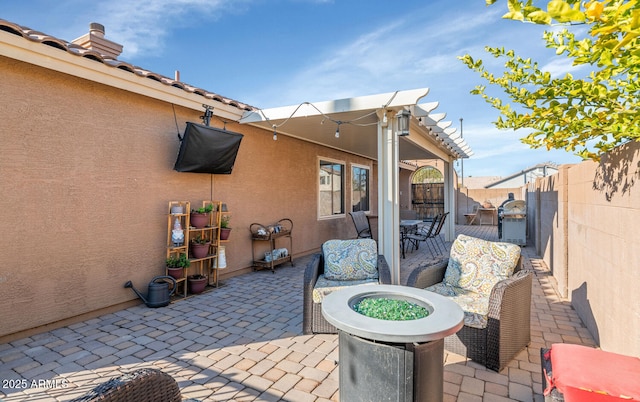 view of patio featuring fence and grilling area