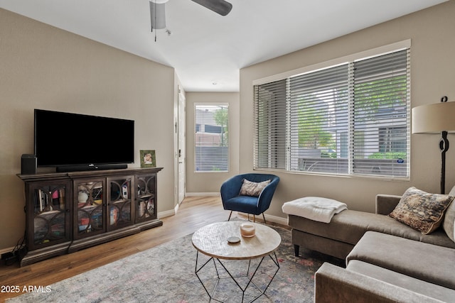 3633 N 3rd Ave Unit 1035, Phoenix, AZ 85013 - living room featuring wood finished floors, a ceiling fan, and baseboards