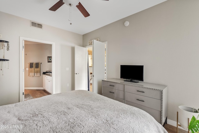 3633 N 3rd Ave Unit 1035, Phoenix, AZ 85013 - bedroom featuring wood finished floors, baseboards, ensuite bathroom, and a ceiling fan