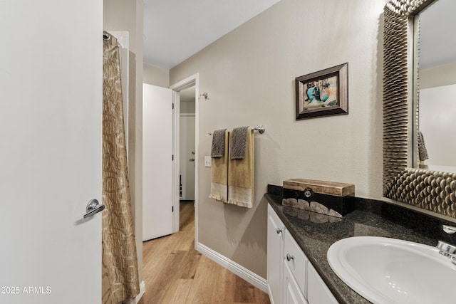 3633 N 3rd Ave Unit 1035, Phoenix, AZ 85013 - bathroom featuring wood finished floors, vanity, and baseboards