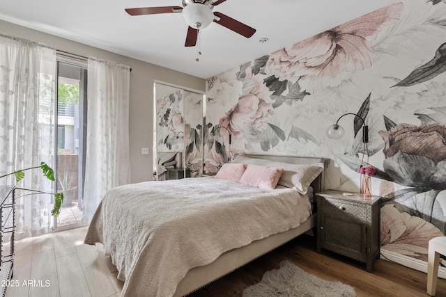 3633 N 3rd Ave Unit 1035, Phoenix, AZ 85013 - bedroom with access to exterior, wood finished floors, wallpapered walls, and a ceiling fan