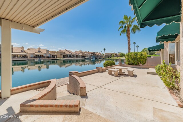 exterior space featuring a water view and a patio area