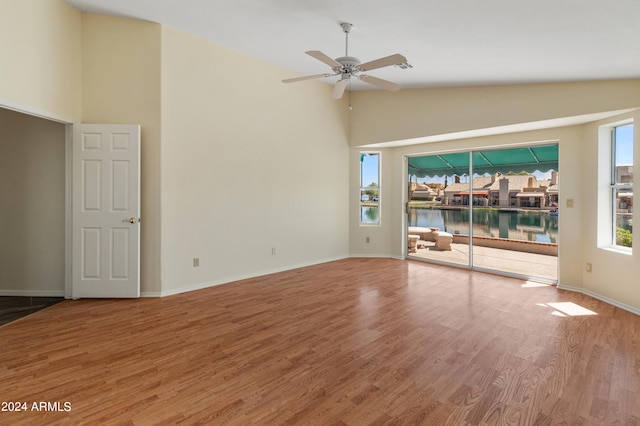 unfurnished room with lofted ceiling, ceiling fan, and hardwood / wood-style flooring