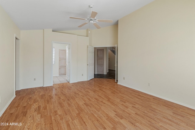 unfurnished bedroom featuring ceiling fan, ensuite bath, and light hardwood / wood-style floors