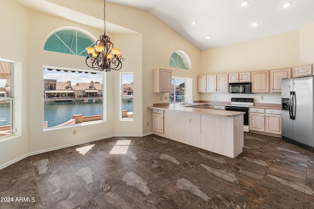 kitchen featuring light brown cabinets, stainless steel fridge, kitchen peninsula, white range with electric cooktop, and a notable chandelier