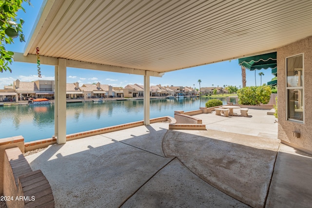 view of patio / terrace with a boat dock and a water view