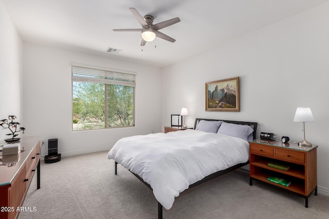 bedroom with light colored carpet, baseboards, and a ceiling fan