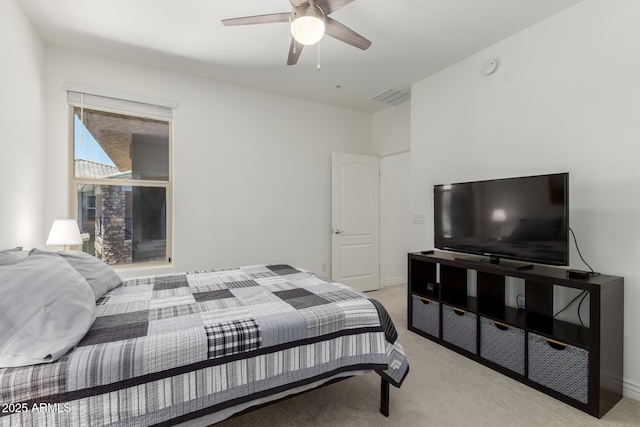 bedroom featuring light colored carpet and ceiling fan