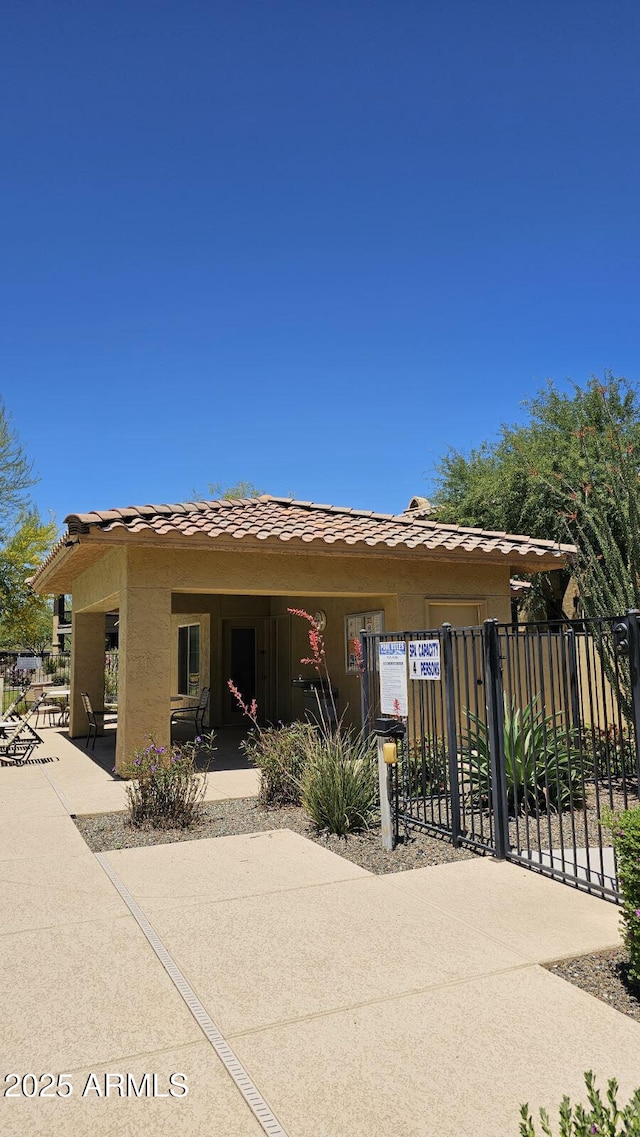 view of front of property with fence and a tile roof