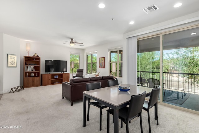 dining room with light colored carpet, a ceiling fan, and recessed lighting