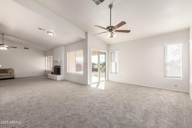 unfurnished living room featuring ceiling fan, lofted ceiling, and a healthy amount of sunlight