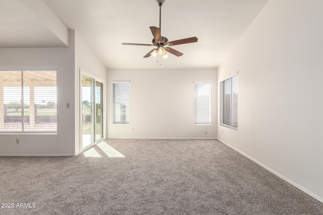 carpeted empty room featuring vaulted ceiling and ceiling fan