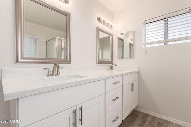 bathroom with walk in shower and vanity