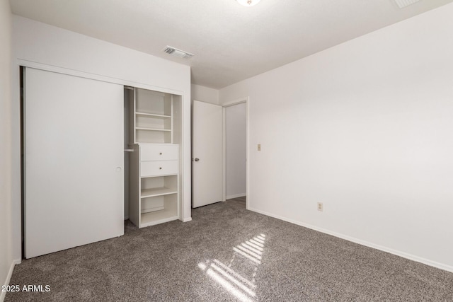 unfurnished bedroom featuring carpet and a closet