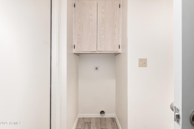 laundry room featuring hookup for an electric dryer and cabinets