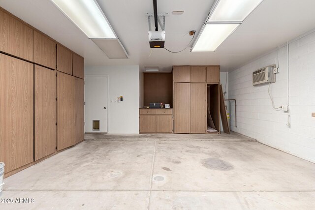 garage with a wall mounted AC and a garage door opener