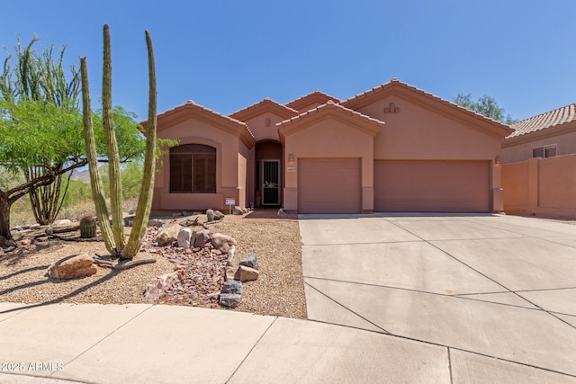 14657 N 103rd Way, Scottsdale, AZ 85255 - mediterranean / spanish-style home featuring a garage, driveway, stucco siding, and a tile roof