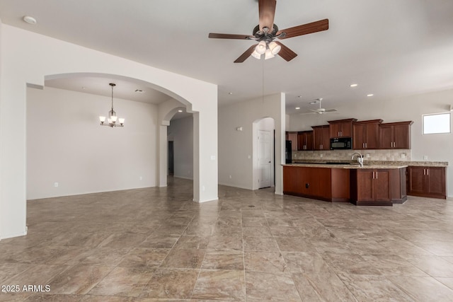 14657 N 103rd Way, Scottsdale, AZ 85255 - kitchen featuring open floor plan, ceiling fan, black microwave, arched walkways, and hanging light fixtures