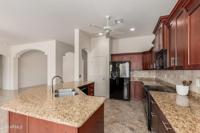 14657 N 103rd Way, Scottsdale, AZ 85255 - kitchen with black appliances, a ceiling fan, arched walkways, tasteful backsplash, and recessed lighting