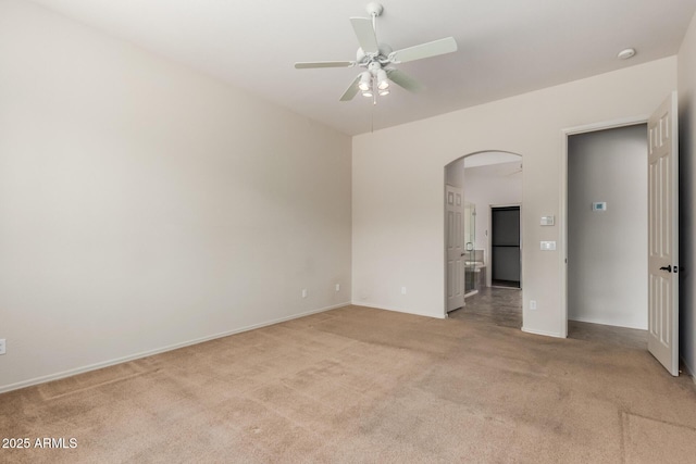 14657 N 103rd Way, Scottsdale, AZ 85255 - spare room featuring arched walkways, light colored carpet, ceiling fan, and a smoke detector