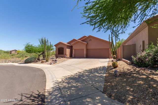 14657 N 103rd Way, Scottsdale, AZ 85255 - mediterranean / spanish-style home with concrete driveway, stucco siding, an attached garage, and a tile roof