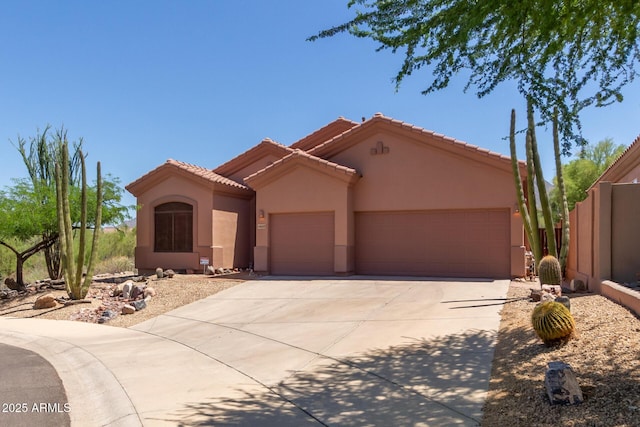 14657 N 103rd Way, Scottsdale, AZ 85255 - mediterranean / spanish home featuring a garage, concrete driveway, stucco siding, and a tile roof