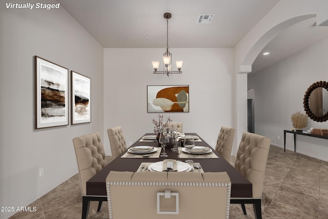 14657 N 103rd Way, Scottsdale, AZ 85255 - dining space with arched walkways and a chandelier