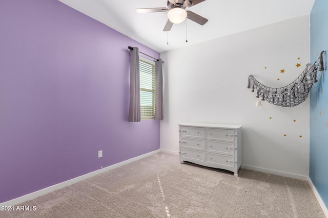 unfurnished bedroom featuring ceiling fan and light carpet