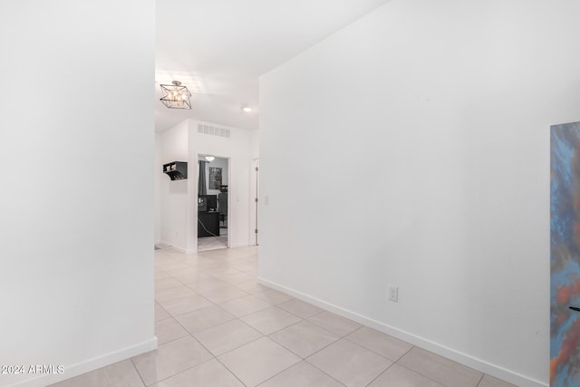 corridor with light tile patterned flooring