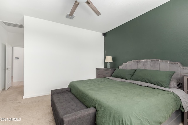 bedroom featuring ceiling fan, lofted ceiling, and light carpet