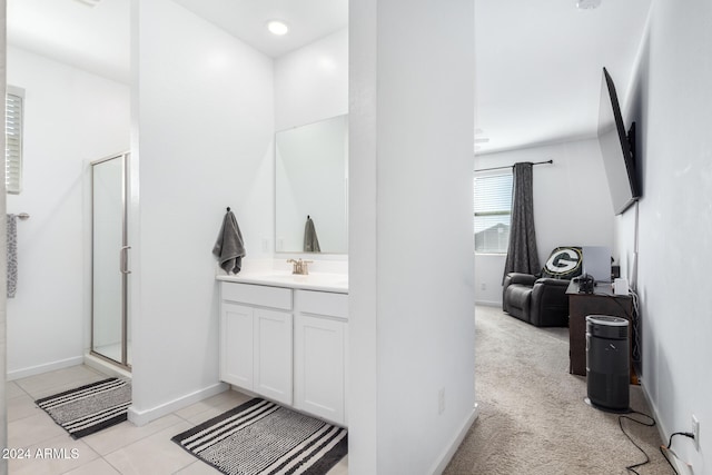 bathroom with tile patterned floors, vanity, and a shower with shower door