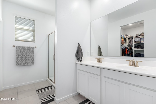 bathroom featuring tile patterned flooring, vanity, and walk in shower