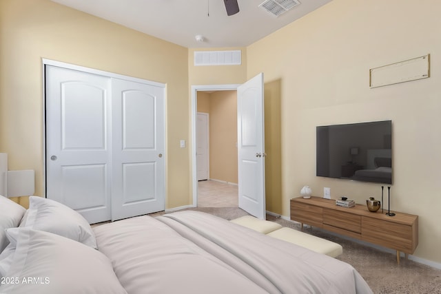 bedroom with light carpet, a closet, visible vents, and baseboards