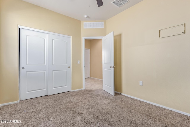 unfurnished bedroom with light carpet, baseboards, visible vents, and a closet