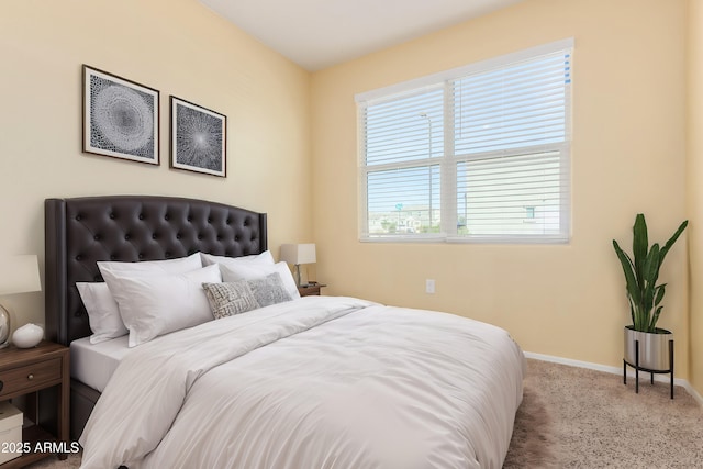 bedroom featuring light carpet and baseboards