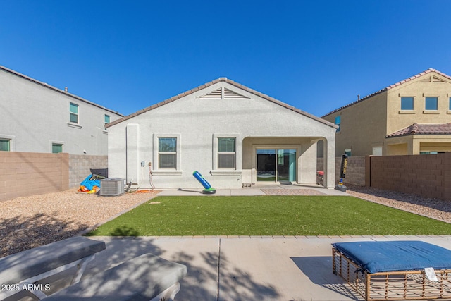 rear view of house with a fenced backyard, central air condition unit, a yard, stucco siding, and a patio area