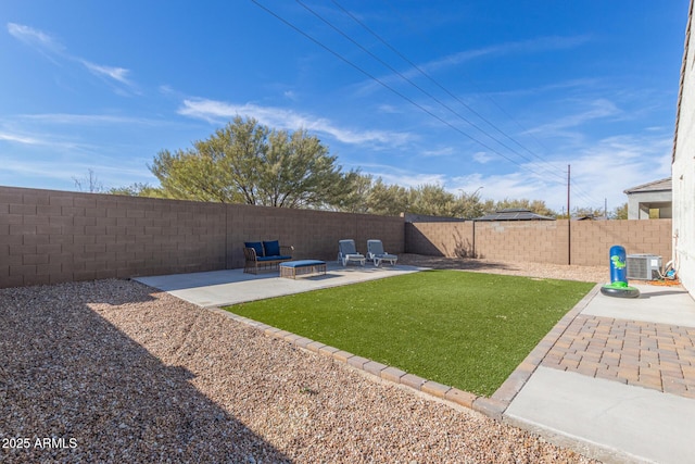 view of yard with an outdoor fire pit, a patio area, cooling unit, and a fenced backyard