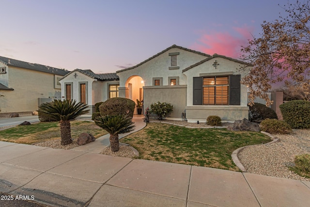 mediterranean / spanish-style house with a yard