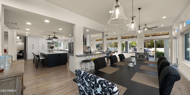 dining area with light wood-style floors, visible vents, a ceiling fan, and recessed lighting