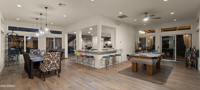 interior space with light wood finished floors, visible vents, a sink, and recessed lighting