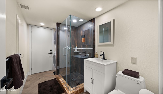 bathroom featuring toilet, recessed lighting, vanity, visible vents, and a stall shower