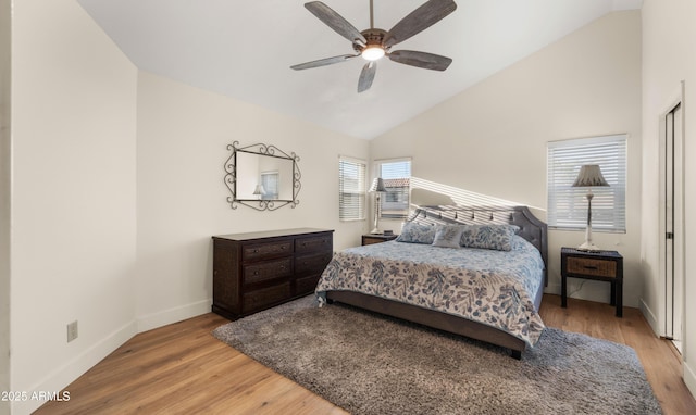 bedroom with lofted ceiling, ceiling fan, wood finished floors, and baseboards