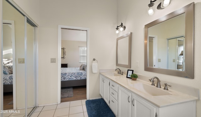 full bath with tile patterned floors, a sink, and ensuite bathroom