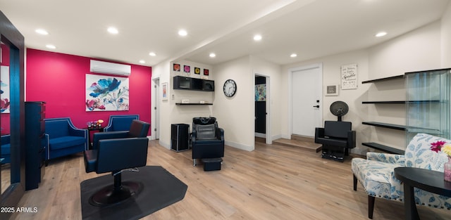 living room with recessed lighting, wood finished floors, baseboards, and a wall mounted AC