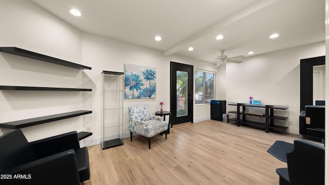 living area with beamed ceiling, light wood-type flooring, a ceiling fan, and recessed lighting