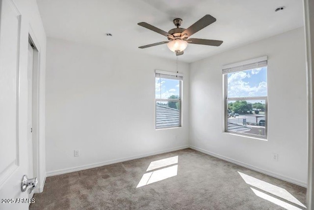 unfurnished room featuring carpet, ceiling fan, and baseboards