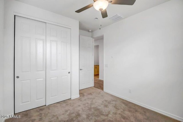 unfurnished bedroom featuring ceiling fan, carpet flooring, visible vents, baseboards, and a closet