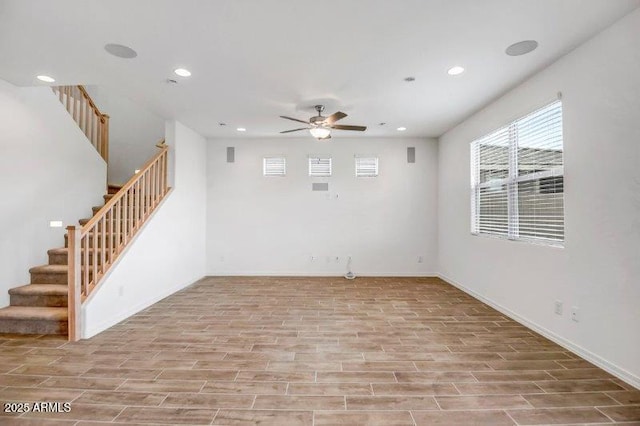 spare room featuring recessed lighting, wood finish floors, ceiling fan, and stairs